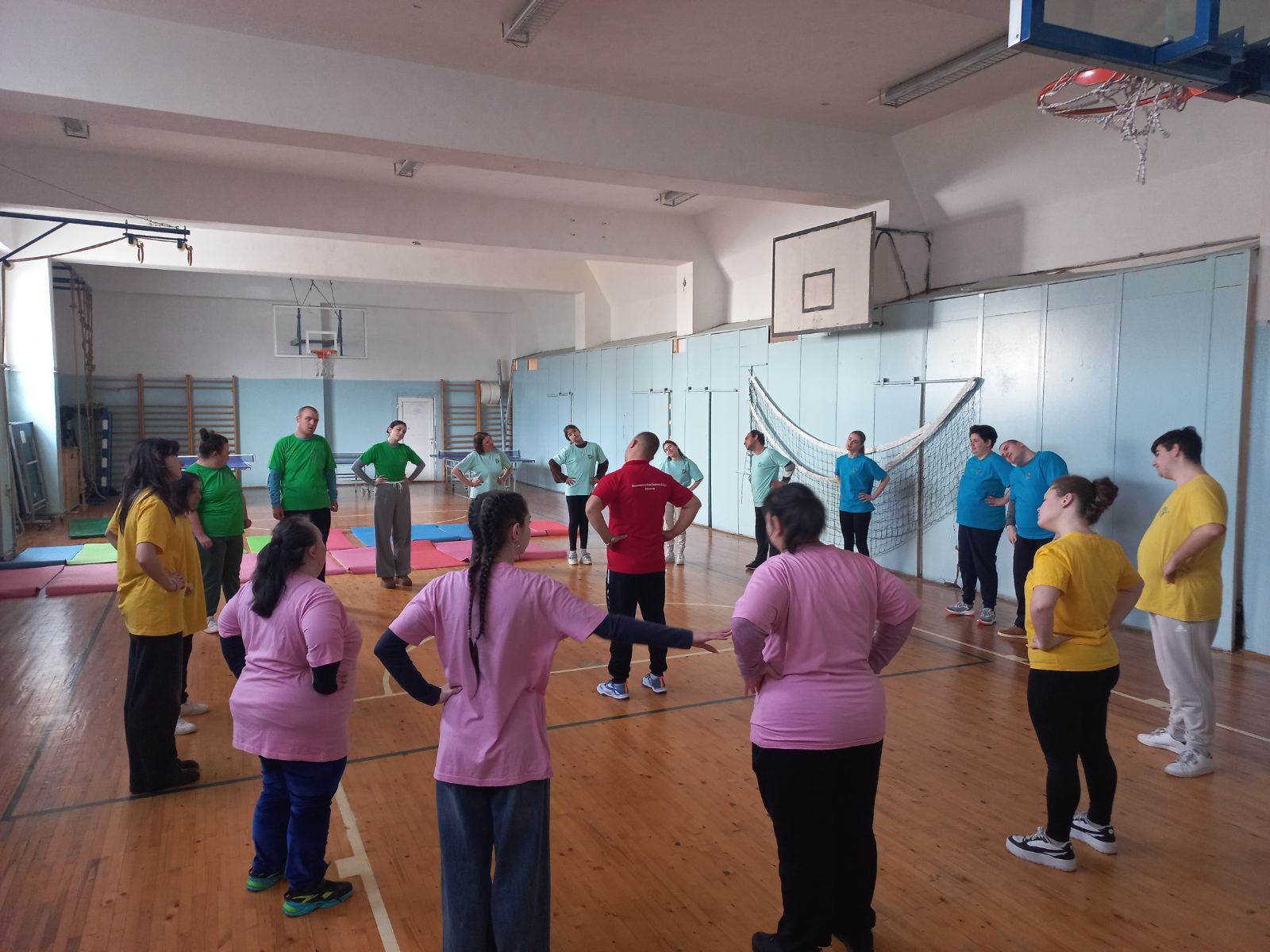 Participants in colourful t-shirts standing in a circle during a group exercise session in the North Macedonian Inclusive Club branch