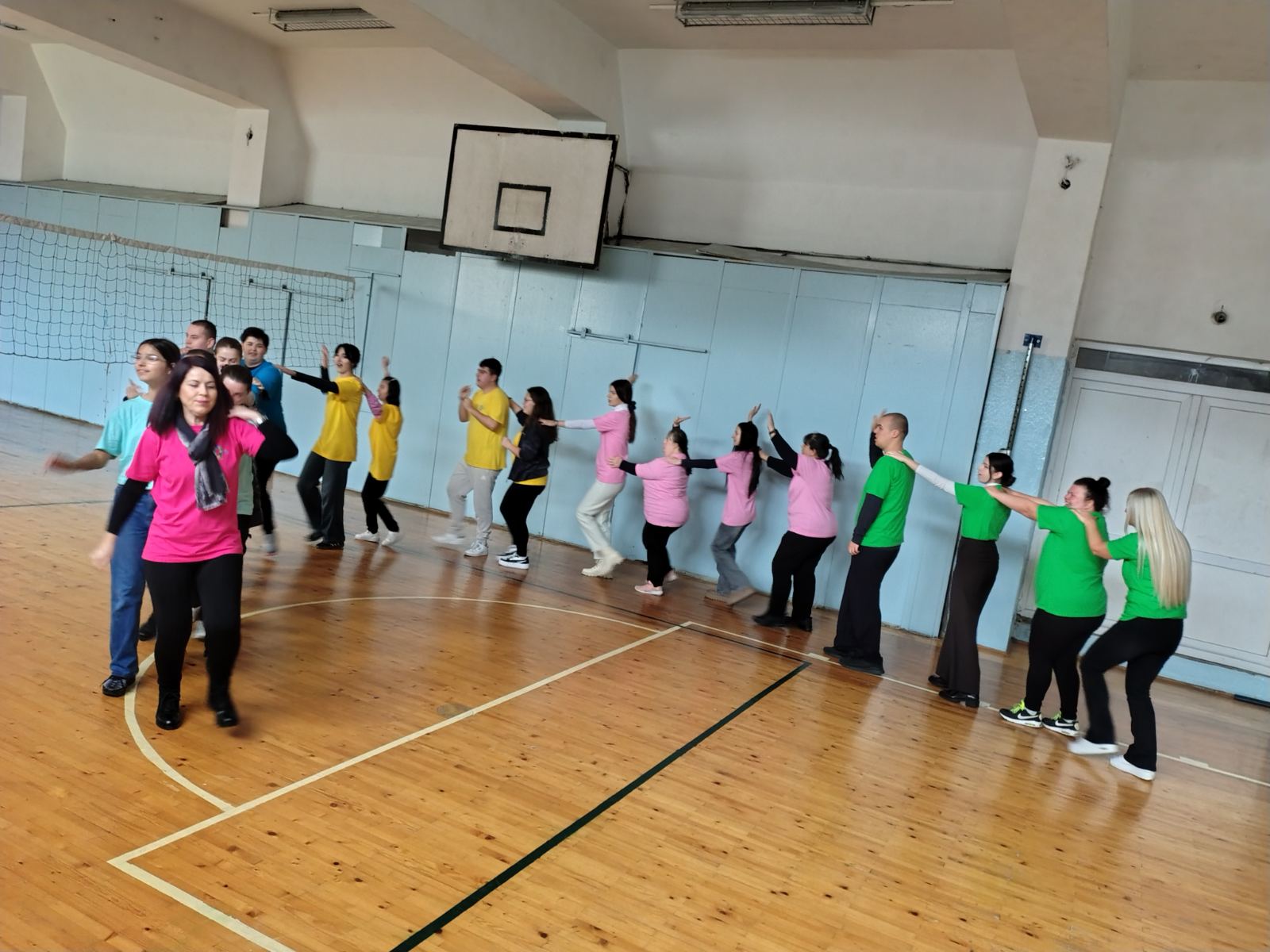 Students taking part in a coordinated movement activity in a gymnasium during the North Macedonian Inclusive Club programme