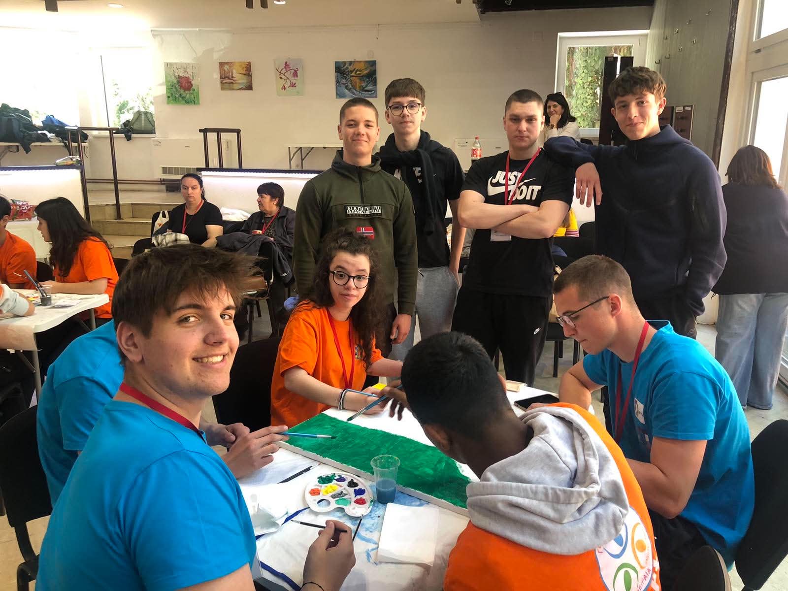 Project participants collaborating on a group painting during an Art activity at the Special (Olympic) Games in Daruvar