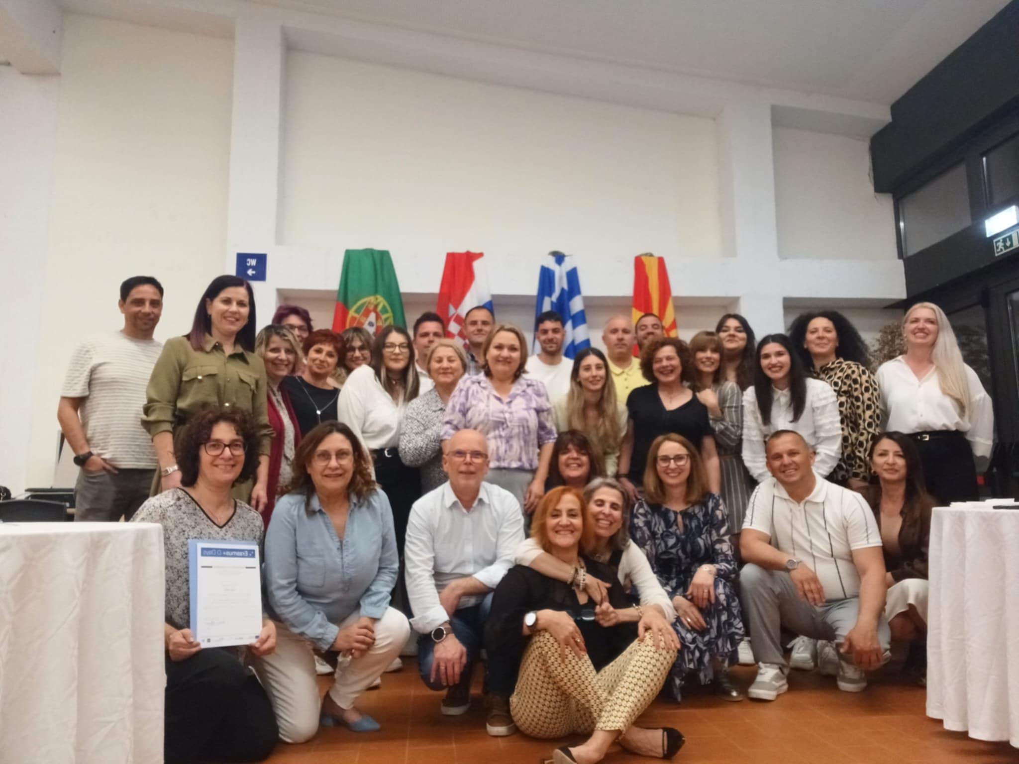 International participants posing together in front of partner country flags during the first D (special) DAYS training event