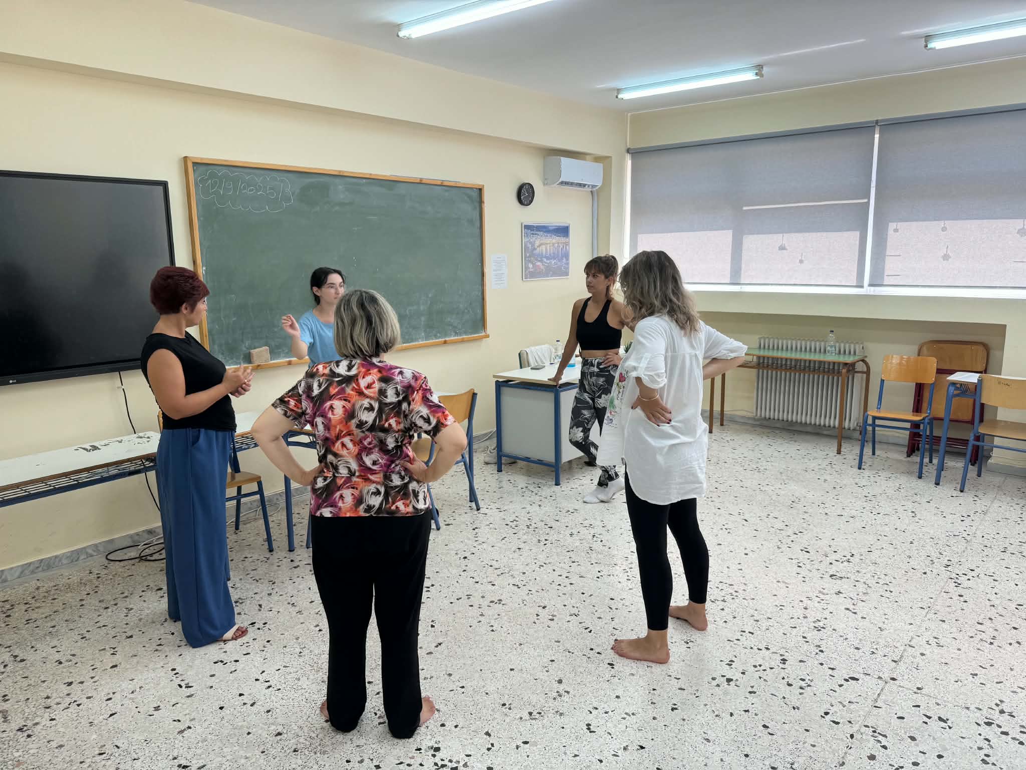 Teachers discussing together in a classroom during the second D (special) DAYS training event